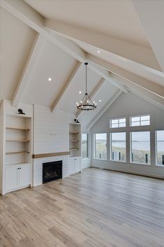 an empty living room with wood flooring and white painted walls on the other side