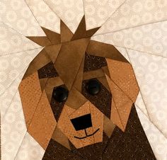 a dog made out of brown paper on top of a white sheet with circles around it