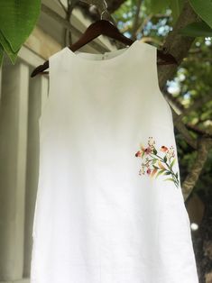 ❤ The white linen hand embroidered dress is very soft, skin friendly, breezy and comfortable.  ❤ Item description: - A lovely dress with embroidered wild flowers motifs. - Material: linen, button, embroidery threads. - Environmentally friendly. - This dress is very useful, go with any outfit, that can be used to go out, go shopping...    It is a perfect gift for yourself or your beloved.  ❤ Care instructions:      The best way to wash embroidery cloth is to put it in soapy water (with a mild detergent and cold water at 86 ºF/30oС) for 20 minutes. Try to not wash the item with other clothing that might cause damage, such as zippers, buttons or different colors. You wash it by hand, and if you have dirty patches on your garment, you can gently rub them, it's best not to rub directly against Flowers Motifs, Onam Outfits, Hand Embroidered Dress, Button Embroidery, Colette Patterns, Embroidery Stitches Beginner, White Linen Dress, Kurti Embroidery Design, White Linen Dresses