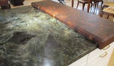 a kitchen counter top that is made out of wood and marble with an iron edge