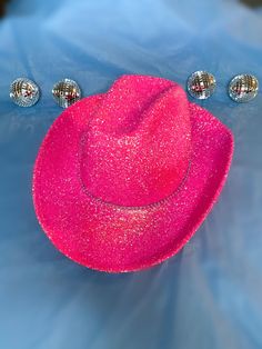 Pink Glitter with Rhinestone Band Cowboy Hat. This cowboy hat is the perfect addition to your party, events, and even cute photos! This is an adult-sized, polyester cowboy hat sealed in glitter with a single rhinestone band. The glitter is only on the top of the hat ensuring that it will not get in your hair! The bottom of the hat is pink matching the glitter color. The hat circumference is 23 inches. Keep in mind that this is not a fitted cowboy hat, one size fits most but it ranges on the larg Western Fedora With Curved Brim For Parties, Western Style Fedora With Curved Brim For Parties, Country Style Fedora Party Hat, Country Style Short Brim Hat For Party, Country Style Fedora Hat For Party, Western Style Fedora Party Hat, Western Style Fedora Hat For Party, Taylor Swift Lover Cowboy Hat, Country Style Wide Brim Party Hat