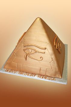 an egyptian pyramid with the eye of horush on it's side, in gold