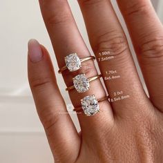 three different sizes of engagement rings on someone's hand with measurements for each ring