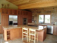 a large kitchen with an island in the middle