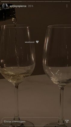 two wine glasses sitting next to each other