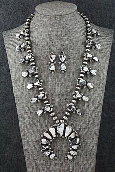 This stunningly beautiful White Buffalo and sterling silver squash blossom necklace and earrings set was made by Navajo silversmith Joe Piaso. The back of the Naja is signed JP and stamped Sterling.Necklace: 22"Naja:Length: 2 3/8"Width: 2 1/2"Blossom:Length: 1 1/8"Width: 1/2"Earrings:Length: 1 5/8"Width: 1/2"Free shipping on all orders! We ship with USPS and always include tracking. All orders ship within a day of payment.Returns are accepted up to 30 days after you receive your order. Just send Western Style Teardrop Silver Jewelry, Western Style Silver Teardrop Jewelry, Silver Squash Blossom Necklace, Sterling Necklace, 2 Earrings, Squash Blossom Necklace, Squash Blossom, Necklace And Earrings Set, White Buffalo