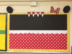 the mickey mouse bulletin board is decorated with red, white and black polka dot paper