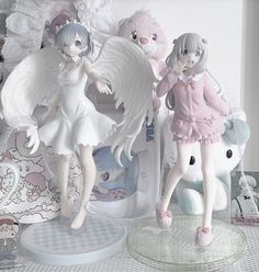 two figurines that are standing next to each other