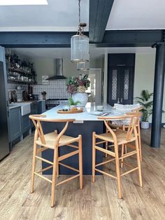 a kitchen with two chairs and a table in it