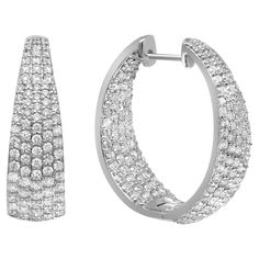 Sparkle all way with these beautiful inside out diamond hoop earrings. Crafted in fine 18K white gold. These earrings feature prong set round brilliant cut diamonds. The stones line only half of the outer hoop and half of the inner hoop. Total diamond weight: 3.31 carats. Diamond color G-H and clarity VS-SI. Earring length: 1 inch. Width: 8.3mm. Total weight: 15.44 grams. Secured with hinged back. Comes with a presentable gift box. Luxury Diamond Earrings With Diamond Eyes, Luxury White Diamond Cut Hoop Earrings, Luxury Fine Jewelry White Gold Hoop Earrings, Luxury White Platinum Hoop Earrings, White Gold Set, Beautiful Inside And Out, Diamond Hoop Earrings, Timeless Accessories, Diamond Color