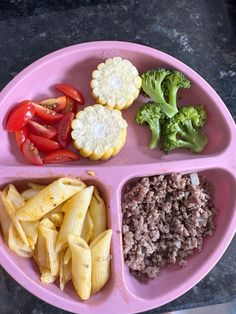 a pink plate filled with different types of food