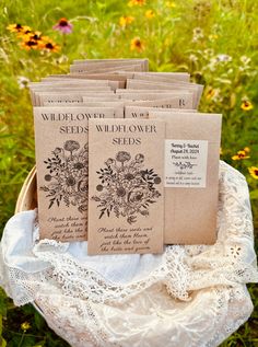 several seed packets in a basket on a lace doily surrounded by wildflowers