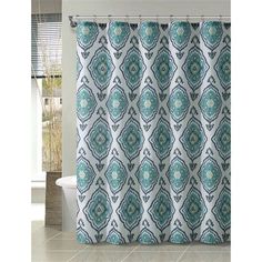 a shower curtain with a blue and white pattern on the outside, in front of a tub