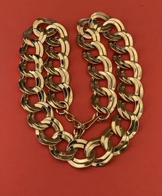 This warm shiny gold tone adjustable collar/choker necklace has shiny links and is in wonderful condition.  The necklace features shiny gold double chain links.  The necklace is 20 inches long and 7/8 inch wide.  It has a hook and chain adjustable clasp.   I specialize in finding fun wearable jewelry.  Please browse my shop for more options.  I box jewelry sales in new gift boxes. I often combine multiple item purchases to save on shipping. Please message me if you wish to combine 3 or more items. Elegant Gold Choker With Chain Strap, Gold Chain Link Metal Choker, Gold Metal Chain Link Choker, Gold Chain Link Choker For Party, Gold Chunky Chain Link Choker, Gold Double Chain Belt For Party, Gold Chunky Chain Choker For Party, Gold Double Chain Necklace For Party, Gold Metal Chain Belt As A Gift