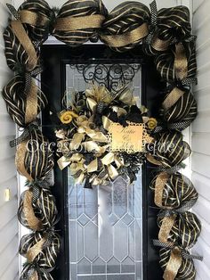 a black and gold wreath on the front door