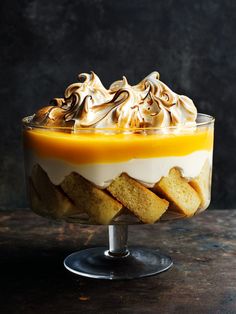 a trifle with whipped cream, orange sauce and toasted marshmallows