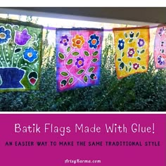 colorful batik flags made with glue are hanging on a line in front of bushes