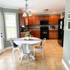 a kitchen with a table and chairs in it