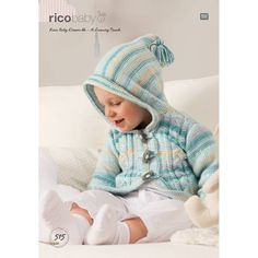 a small child sitting on top of a bed wearing a knitted hat and coat