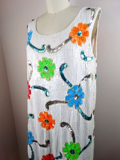 "This is such a unique vintage dress. It's fully embellished with bright and colorful sequins and glass beading in an artsy floral design. It's in excellent condition! Bust - 38/40\" Waist - 38/40\" Hips - 38/40\" Length - 35\" This dress comes from a pet-free and smoke-free home. If you would like more info or have any questions, please don't hesitate to ask!" Neon Vintage, Iridescent Dress, Unique Vintage Dresses, Sequined Dress, Sequin Beading, Embellished Dress, Beaded Dress, Large Size Dresses, Vintage Dress