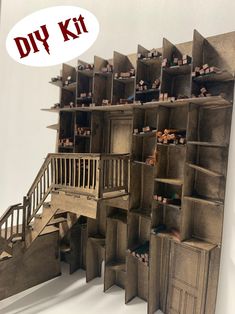 an art installation made out of cardboard with stairs and shelves on each side, in front of a white wall