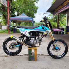 a dirt bike parked on top of a wooden stand