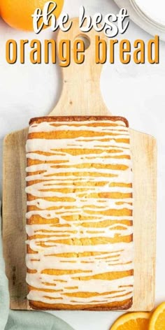 the best orange bread with icing on a cutting board next to sliced oranges