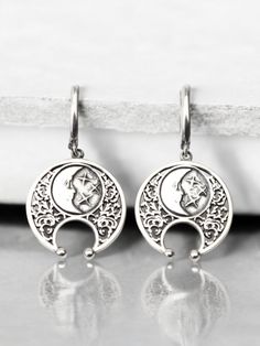 Embrace the mystique of the moon with these stunning half moon earrings. Handcrafted from high-quality sterling silver, these lunula earrings feature an intricate design inspired by Viking jewelry and celestial themes. Perfect for those who love boho style and lunar symbolism, these earrings capture the beauty and mystery of a lunar eclipse. These sterling silver lunula earrings are both elegant and durable, making them ideal for everyday wear or special occasions. The detailed craftsmanship reflects the timeless appeal of Viking jewelry while adding a modern boho twist. Whether you're looking for a unique accessory or a thoughtful gift, these half moon earrings are a perfect choice. Celebrate the celestial charm and Viking heritage with these exquisite half moon earrings. Their handcrafte Celestial Moon Shaped Metal Earrings, Celestial Moon-shaped Metal Earrings, Celestial Moon Phase Moon Earrings, Spiritual Crescent Earrings As Gift, Spiritual Crescent Earrings For Gift, Mystical Metal Earrings With Moon Charm, Celestial Half Moon Earrings With Moon Phase Detail, Bohemian Crescent Moon Charm Earrings, Handmade Moon-shaped Spiritual Earrings