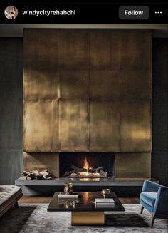 a living room with a couch, coffee table and fire place in front of the fireplace