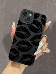 a woman's hand holding an iphone case with black lips on the phone cover