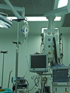 an operating room with monitors and medical equipment