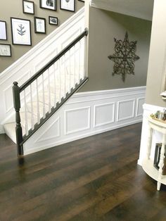 the stairs in this house have been painted white and are decorated with pictures on the wall