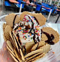 an ice cream sundae with chocolate and sprinkles in a plastic container