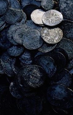 a pile of silver coins sitting on top of each other