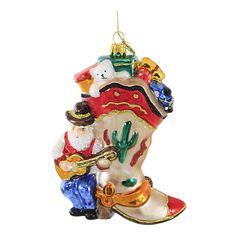 an ornament shaped like a boot with santa clause on it, holding a trumpet