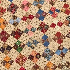 an old quilt with many different colored squares