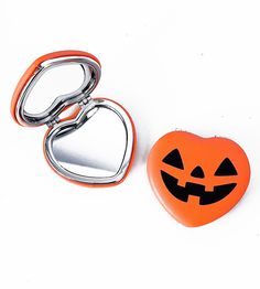 "How CUTE! This spooky cute pocket mirror is heart shaped and features a jack-o-lantern print on the front and my logo on the back. It's made of a soft faux leather material on the outside with metal on the inside. One mirror is regular and the other mirror is a 3x magnification mirror. Super handy!! The mirror measures approximately 2.75\" across." Orange Jack O Lantern, Pocket Mirrors, Halloween Miniatures, Halloween Wall Decor, Spooky Cute, Heart Pocket, My Logo, Halloween Pillows, Halloween Lights