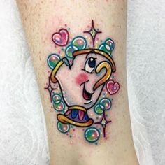 a cartoon character tattoo on the ankle with hearts and stars around it's feet