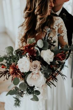 a bride holding a bouquet of flowers in her hands