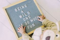 a young child is writing on a sign