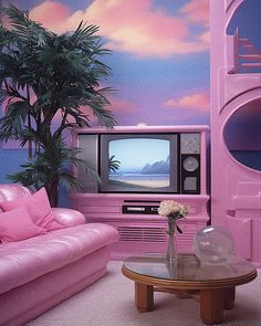 a living room with pink furniture and a palm tree in front of a tv set