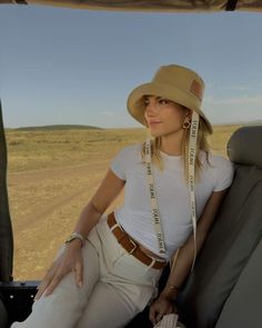 a woman sitting in the back seat of a safari vehicle