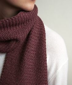 a woman wearing a red scarf and white shirt