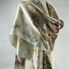 Discover Timeless Elegance with my Luxurious Hand-Dyed Eco-Printed Scarf Elevate your style with my exquisite silk satin scarf, a masterpiece of nature-inspired art and unparalleled craftsmanship. Each piece is hand-dyed and eco-printed, ensuring a unique and sustainable accessory that embodies the beauty of the natural world. Gray with a hint of light this accessory is perfect as a scarf or shawl. It will add a touch of sophistication to any outfit, whether casual or formal! Wrap yourself in elegance and make every moment special with a scarf that reflects your style and values. Embrace the fusion of art and nature with our luxurious hand-dyed eco-printed scarf. Order yours today and experience the difference of truly unique, handcrafted fashion. Light weight, this scarf is approximately Silk Shawl Scarf, Artistic Silk Wedding Scarves, Artistic Silk Scarves For Wedding, Artistic Silk Scarves For Weddings, Bohemian Hand-dyed Silk Scarf, Silk Shawl For Wedding, Satin Shawl, Green Silk Scarf, Sustainable Accessories