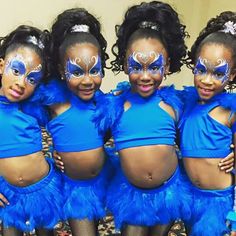 four girls in blue costumes posing for the camera