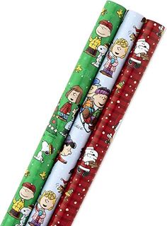 three rolls of wrapping paper with cartoon characters on them, each rolled up in different colors