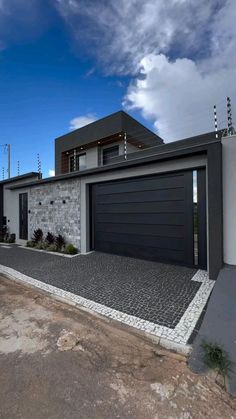 a modern house with two garages on the side