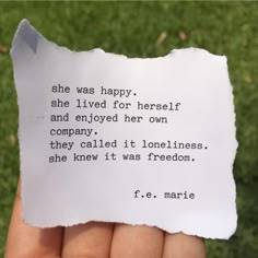 someone holding up a piece of paper that says she was happy, she lived for herself and enjoyed her own company