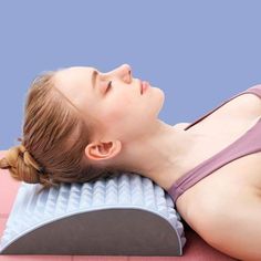 a woman laying on top of a foam pillow