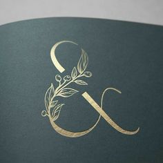 the letter g is made up of gold foil and has an elegant leaf design on it